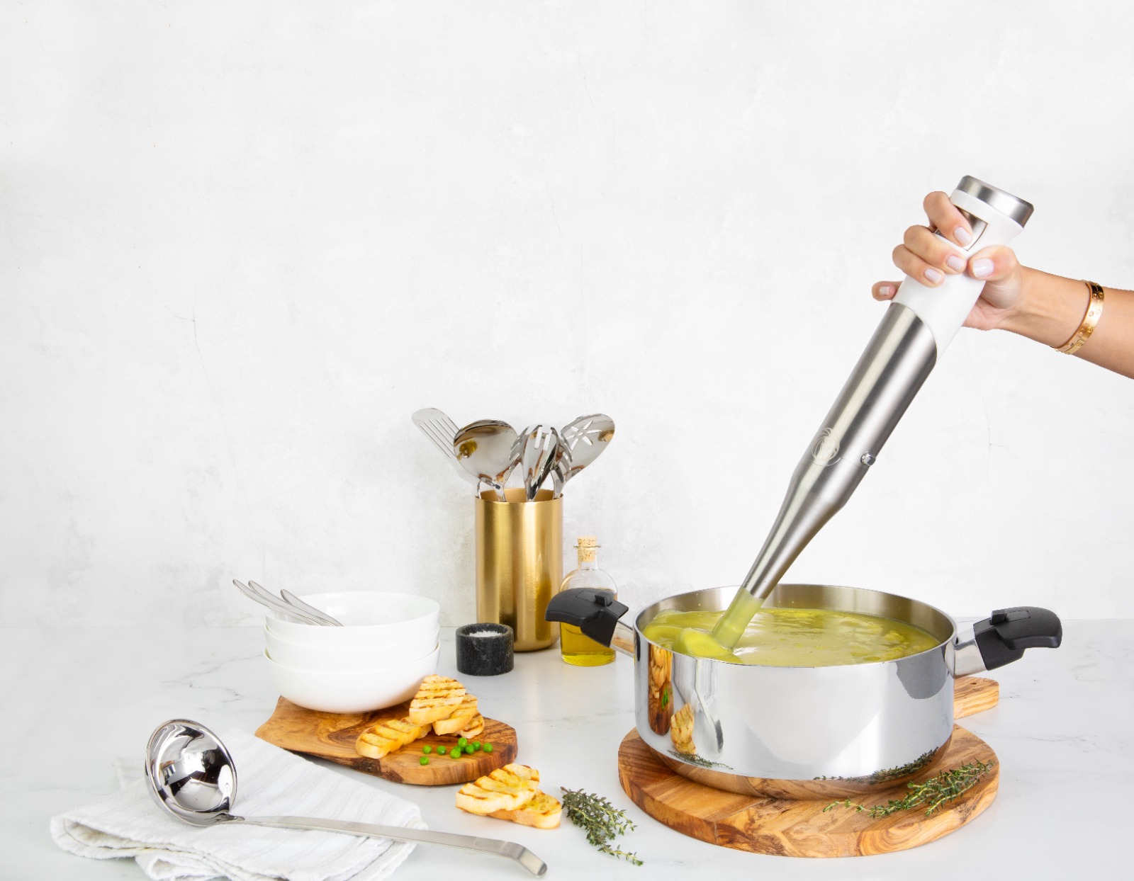 A kitchen scene with a family gathered around a table enjoying a home-cooked meal prepared in Royal Prestige cookware. The image should emphasize the ease of use, the delicious food, and the happy family sharing a meal.